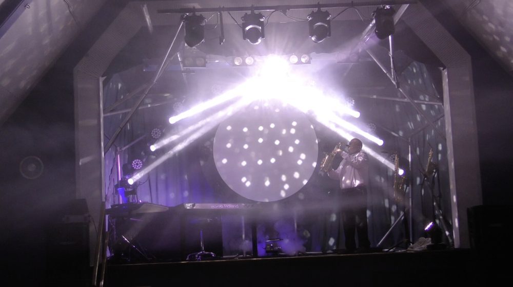 Phil live on saxophone, full lighting rig